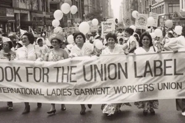 A picture of union workers with a sign reading "Look for the union label."