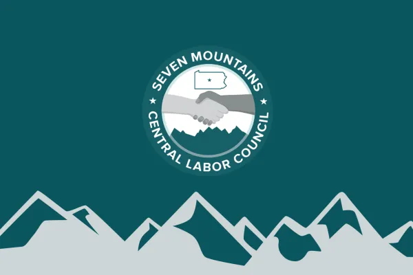 Labor Council logo against background of mountains.
