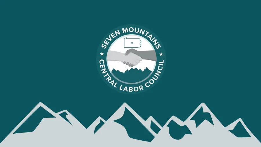 Labor Council logo against background of mountains.